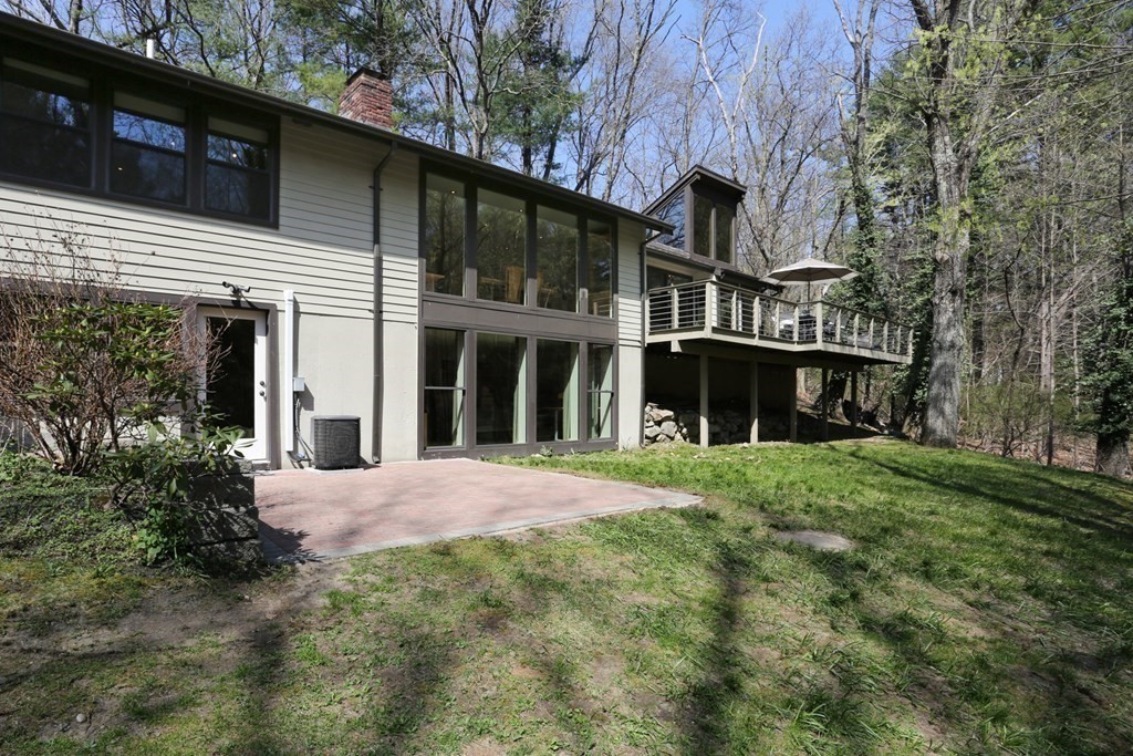 10 Country Corners Road Wayland, MA 01778 - Photo 2 of 32 a front view of a house with a yard and garage