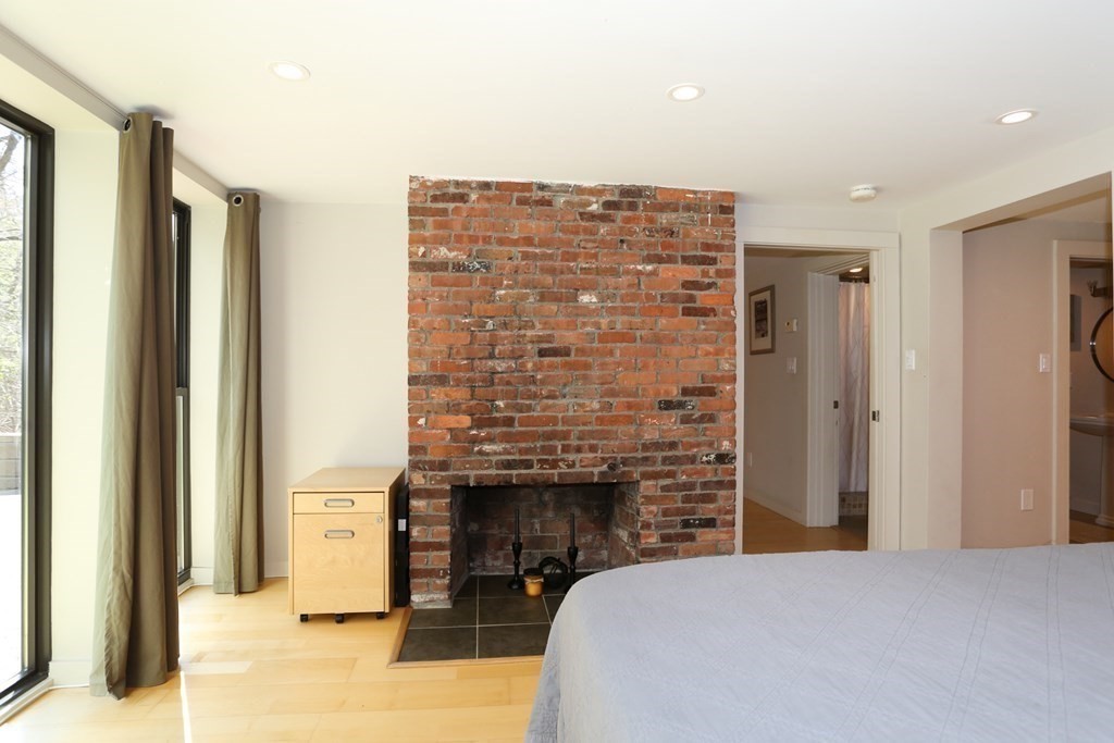 10 Country Corners Road Wayland, MA 01778 - Photo 25 of 32 a bedroom with a bed and a fireplace