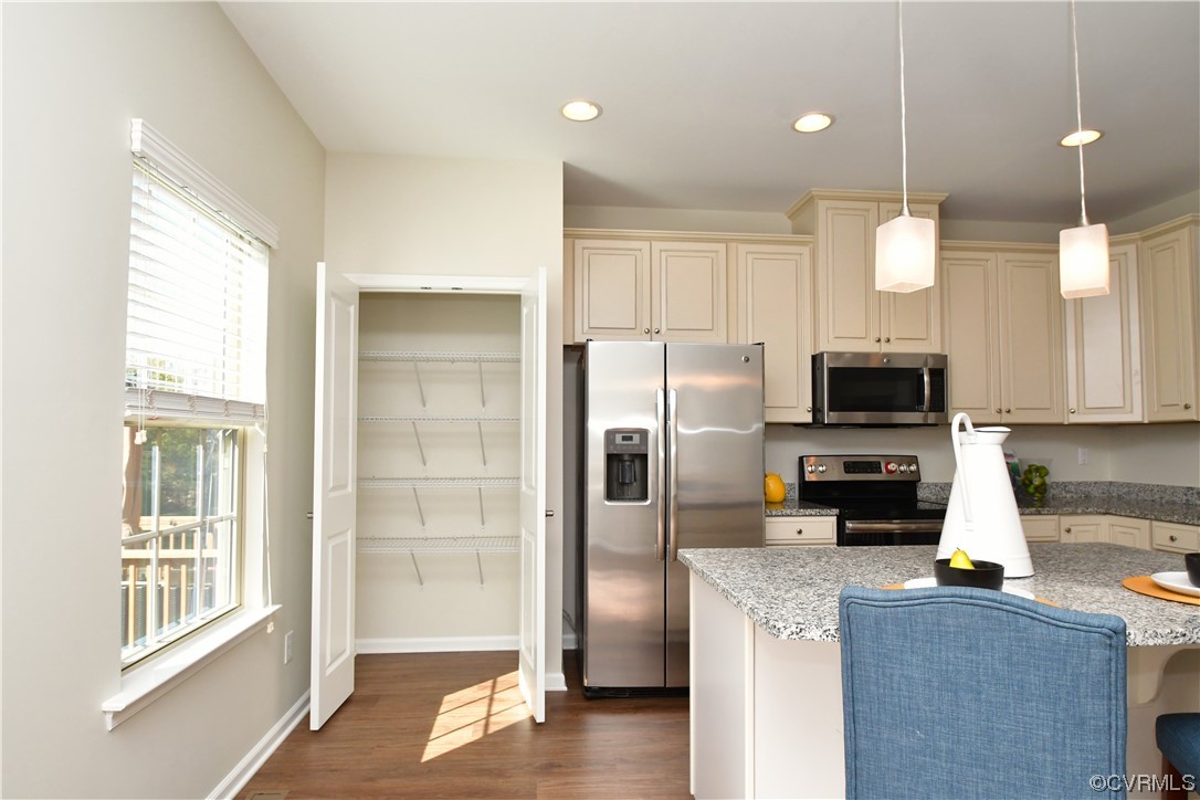 5509 Riverside Heights Way Richmond, VA 23225 - Photo 11 of 28 a kitchen with a refrigerator a microwave a sink and cabinets