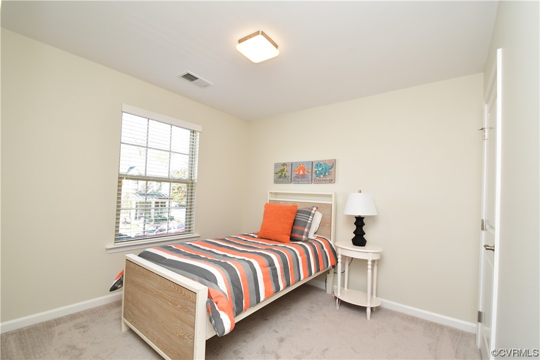 5509 Riverside Heights Way Richmond, VA 23225 - Photo 18 of 28 a bedroom with a bed and window