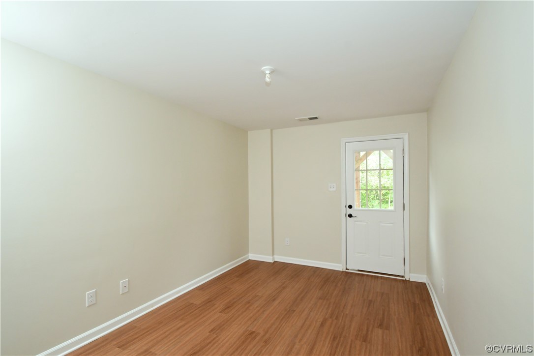 5509 Riverside Heights Way Richmond, VA 23225 - Photo 23 of 28 a view of an empty room with wooden floor and a window