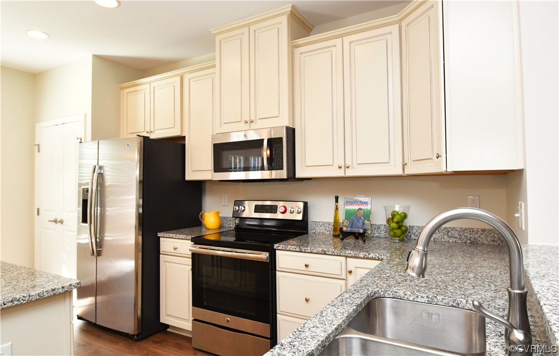5509 Riverside Heights Way Richmond, VA 23225 - Photo 10 of 28 a kitchen with stainless steel appliances granite countertop a refrigerator sink and stove