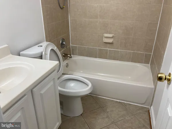 a bathroom with a sink a toilet and bathtub