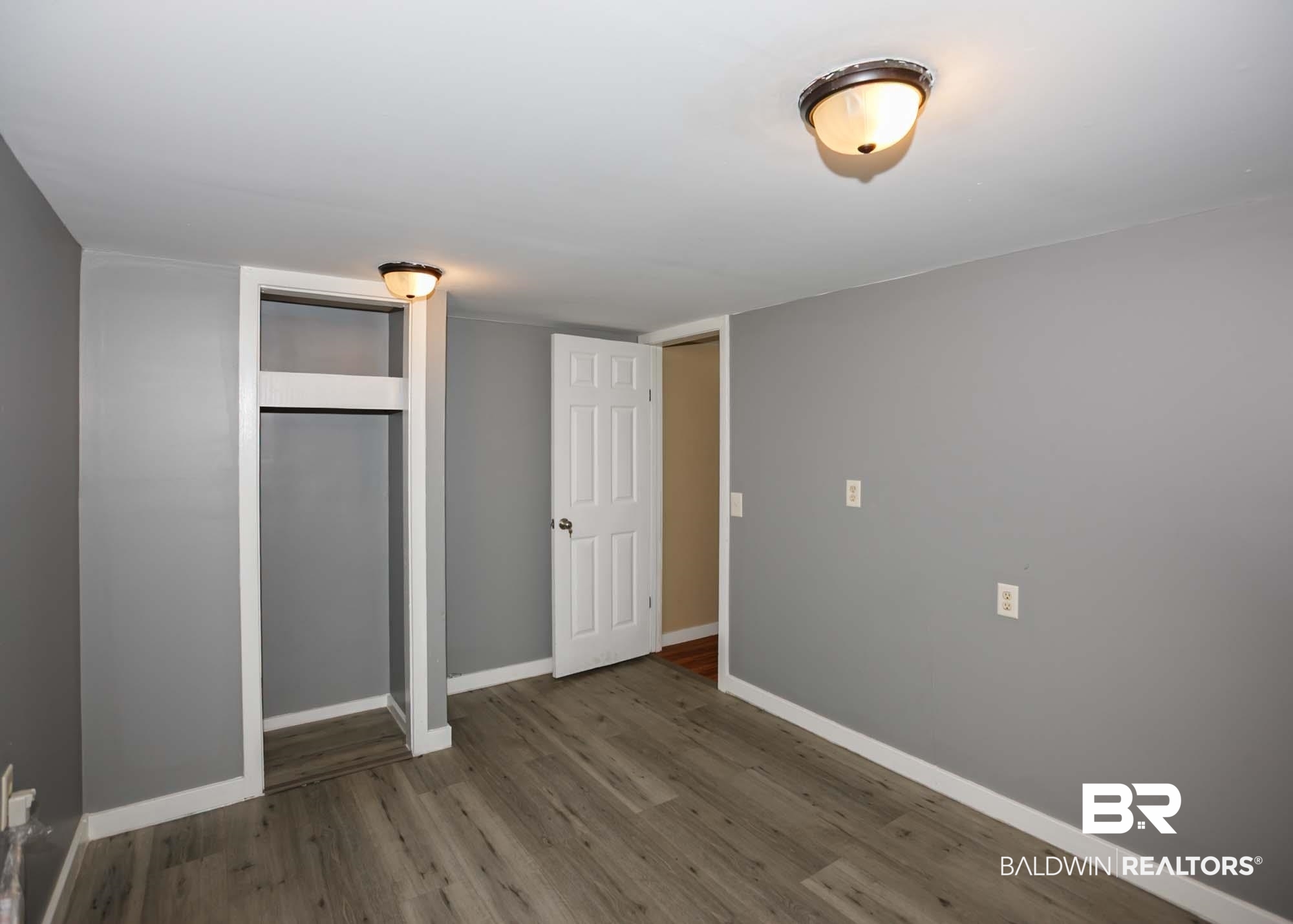 11998 Workman Avenue Foley, AL 36535 - Photo 52 of 59 Unfurnished bedroom featuring wood finished floors and a closet