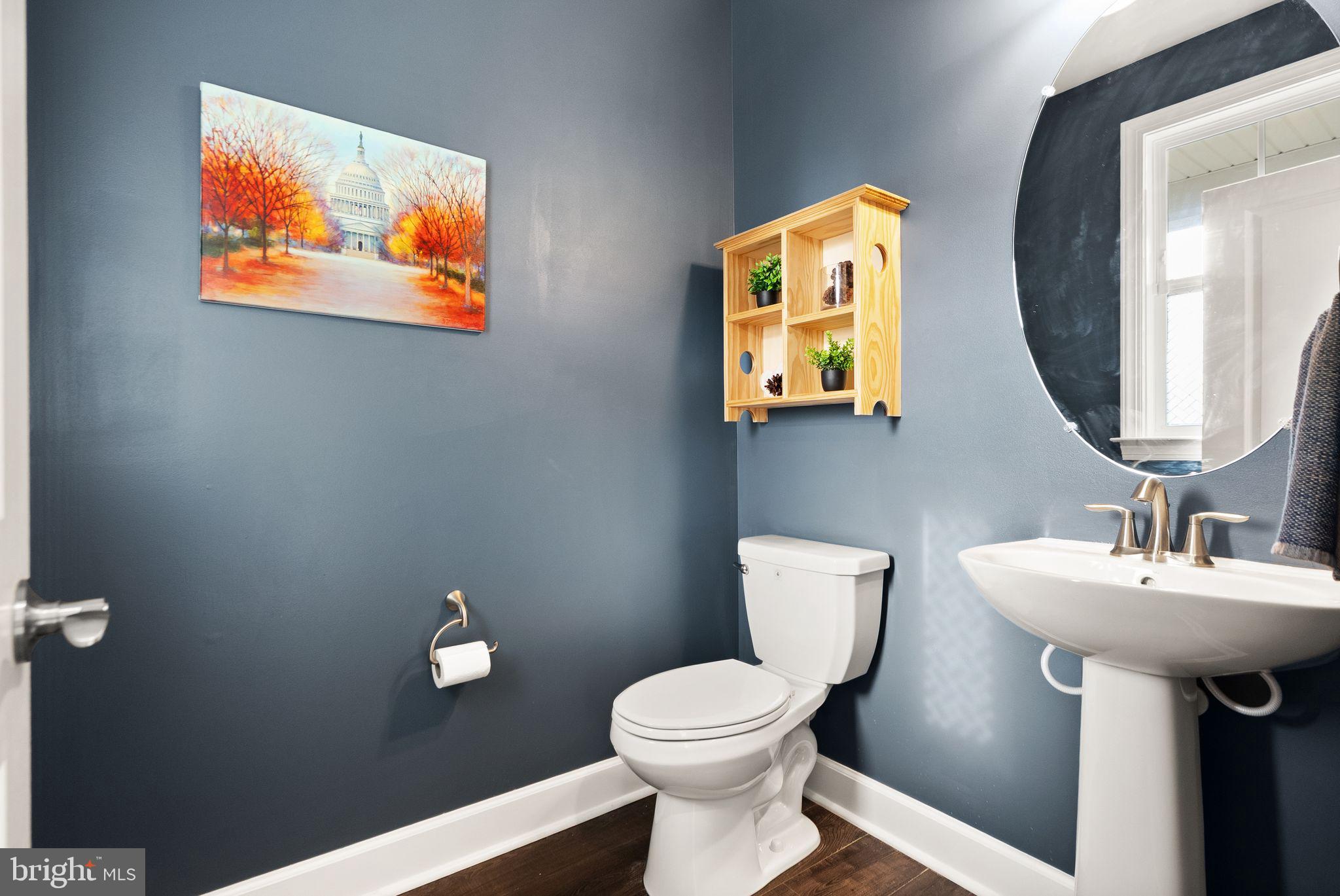 9516 Sanger Street Lorton, VA 22079 - Photo 16 of 45 a bathroom with a toilet a sink and mirror