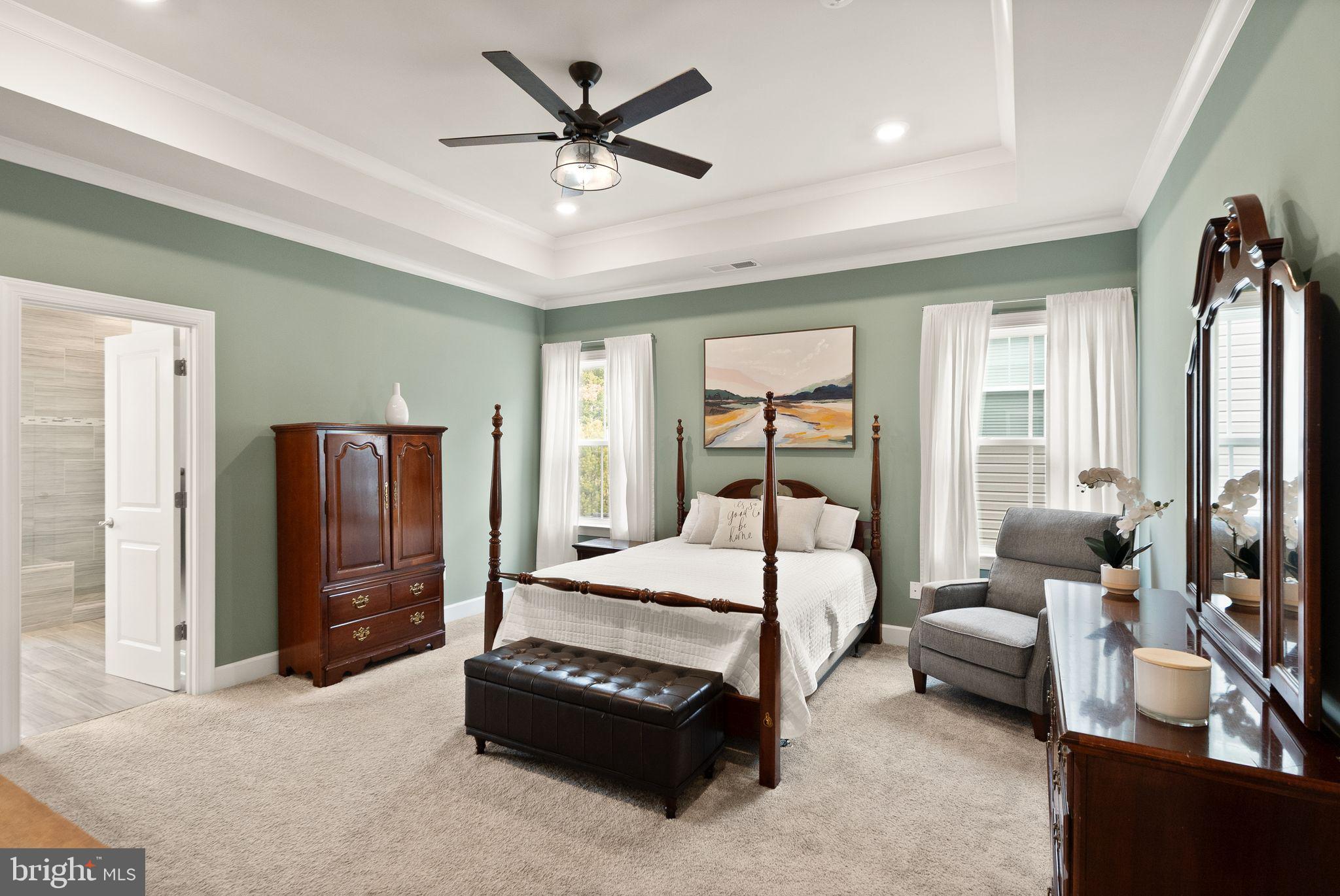 9516 Sanger Street Lorton, VA 22079 - Photo 18 of 45 a bedroom with a bed a dresser and a chandelier