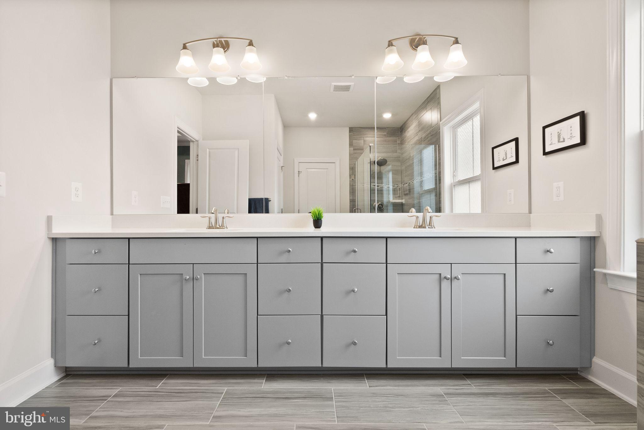 9516 Sanger Street Lorton, VA 22079 - Photo 20 of 45 a bathroom with a sink vanity and a mirror