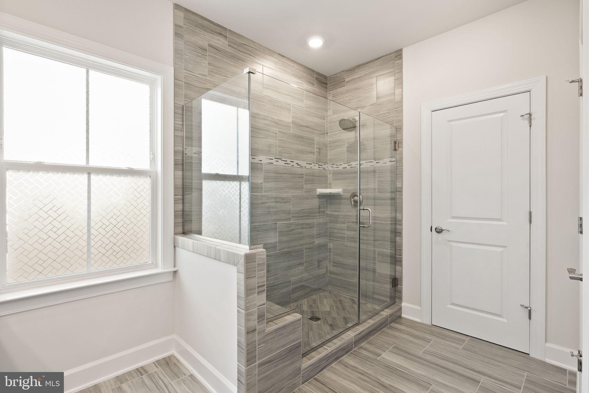 9516 Sanger Street Lorton, VA 22079 - Photo 21 of 45 a bathroom with a shower and a window