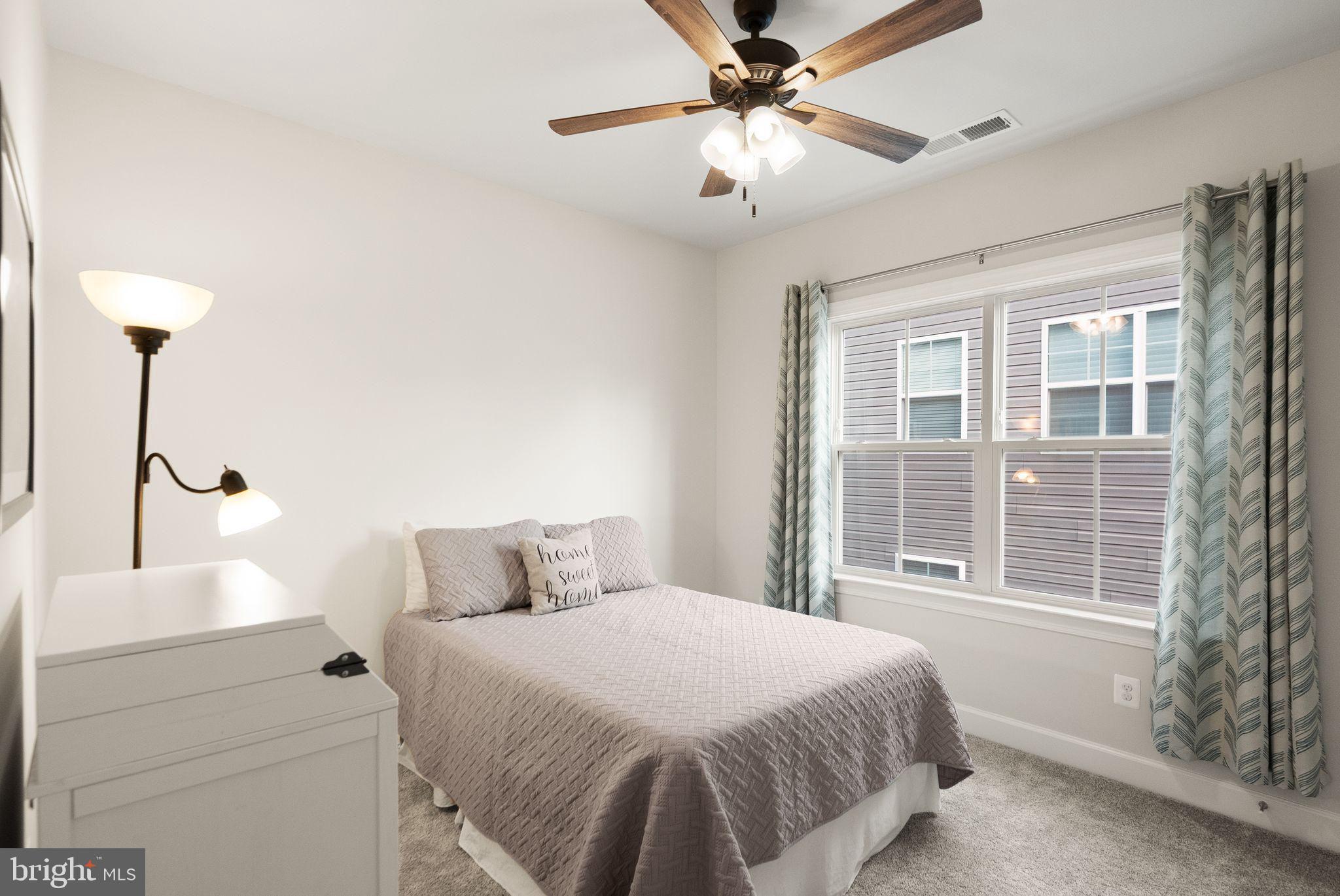 9516 Sanger Street Lorton, VA 22079 - Photo 25 of 45 a bedroom with a large bed and a window