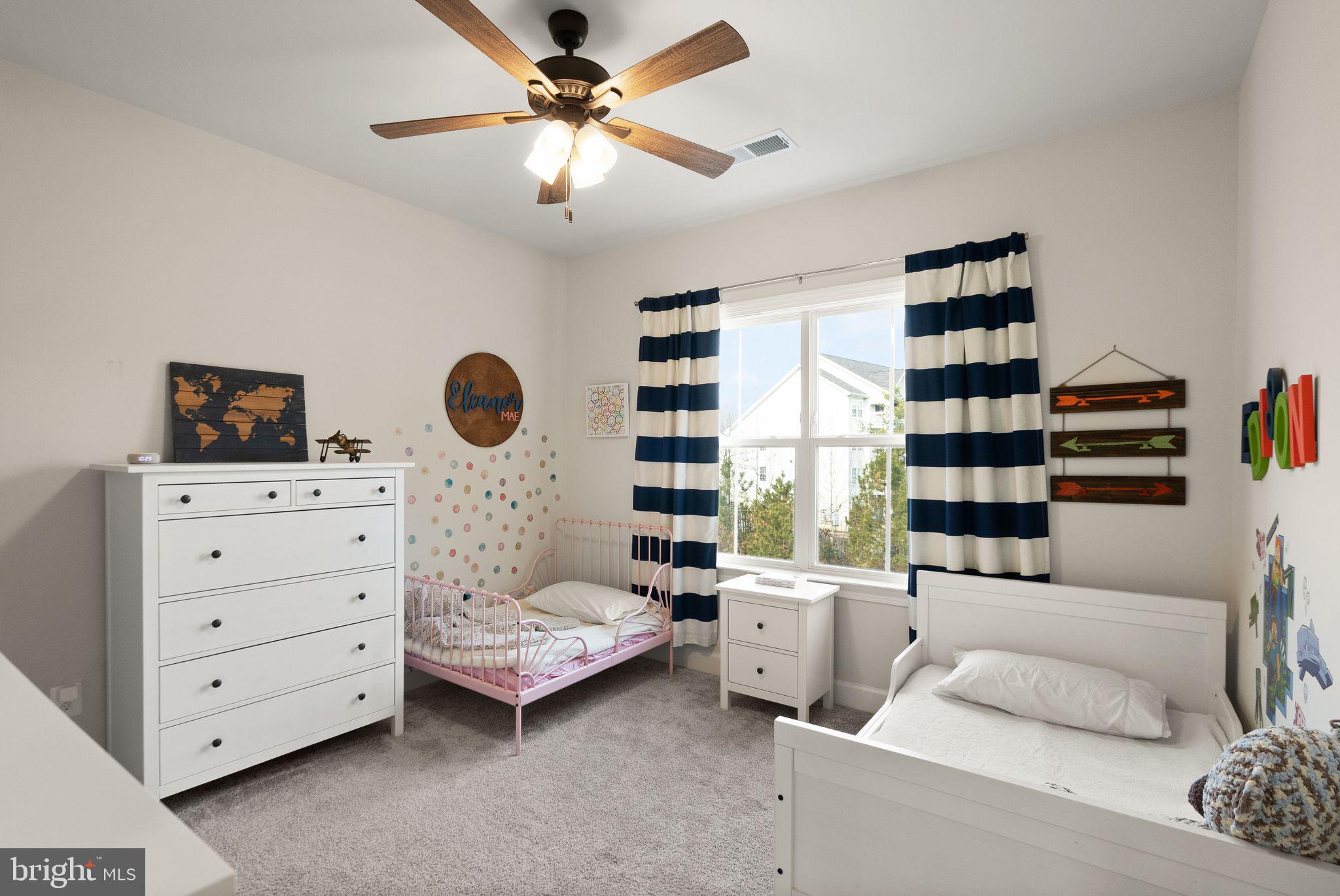 9516 Sanger Street Lorton, VA 22079 - Photo 30 of 45 a bedroom with a bed and a bookshelf