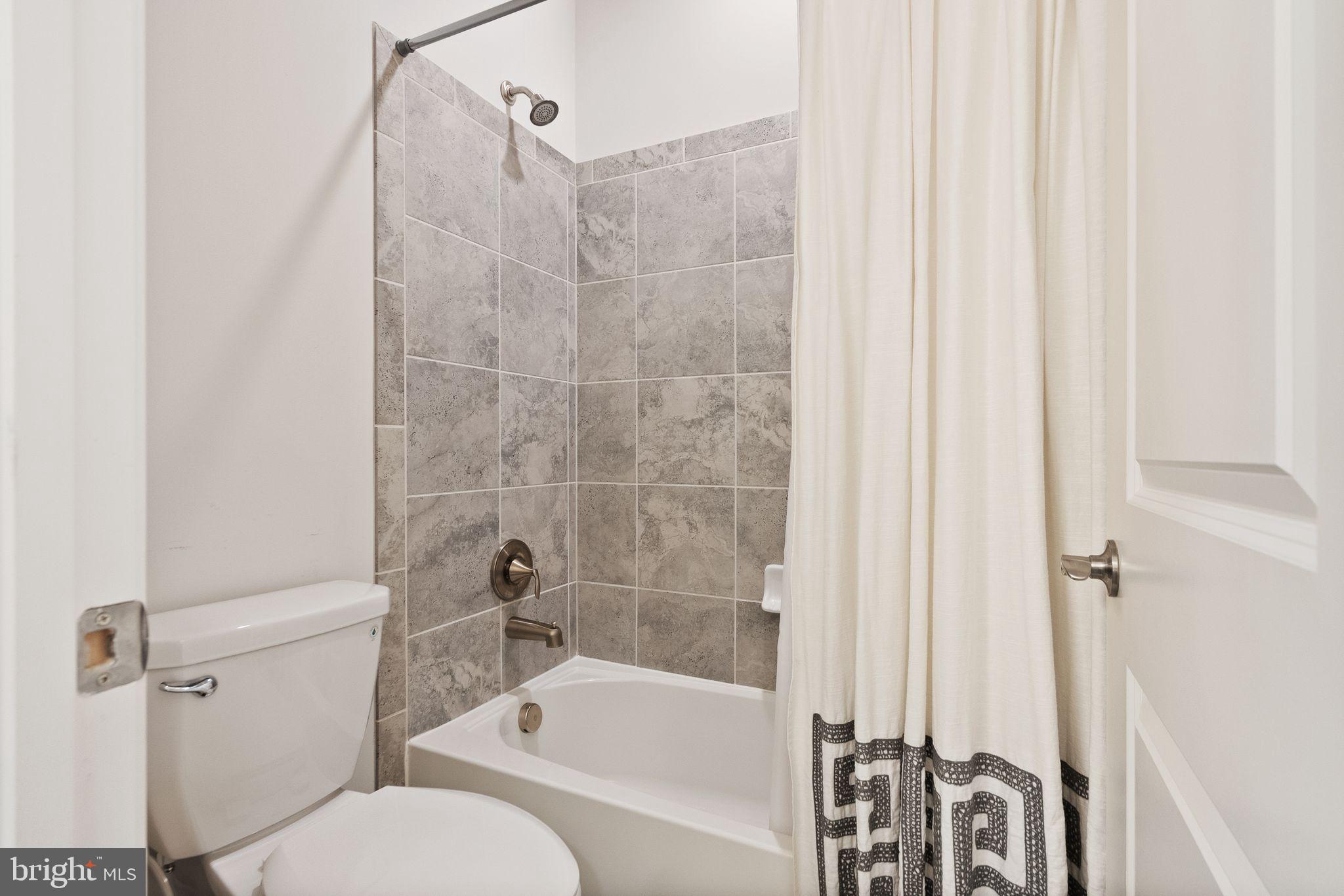 9516 Sanger Street Lorton, VA 22079 - Photo 32 of 45 a bathroom with a toilet and a bathtub