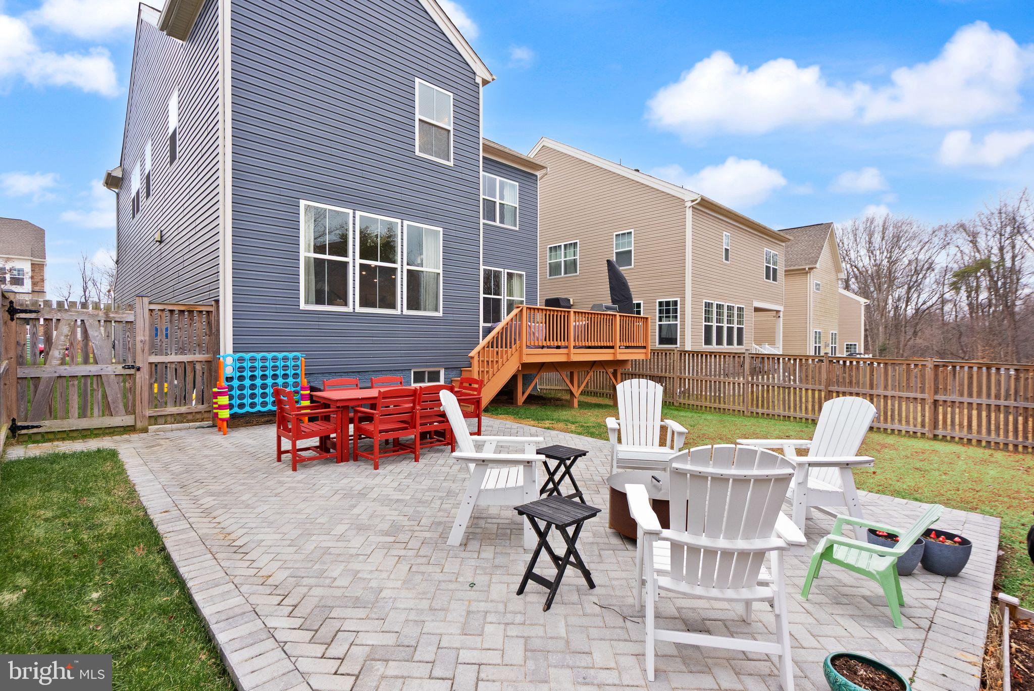 9516 Sanger Street Lorton, VA 22079 - Photo 41 of 45 a backyard of a house with barbeque oven table and chairs