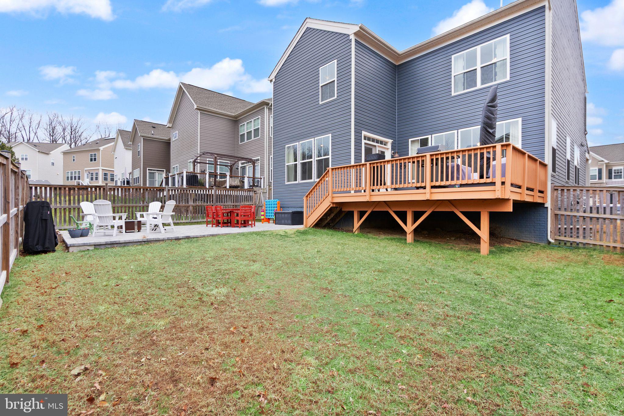 9516 Sanger Street Lorton, VA 22079 - Photo 43 of 45 a backyard of a house with wooden fence and a bench