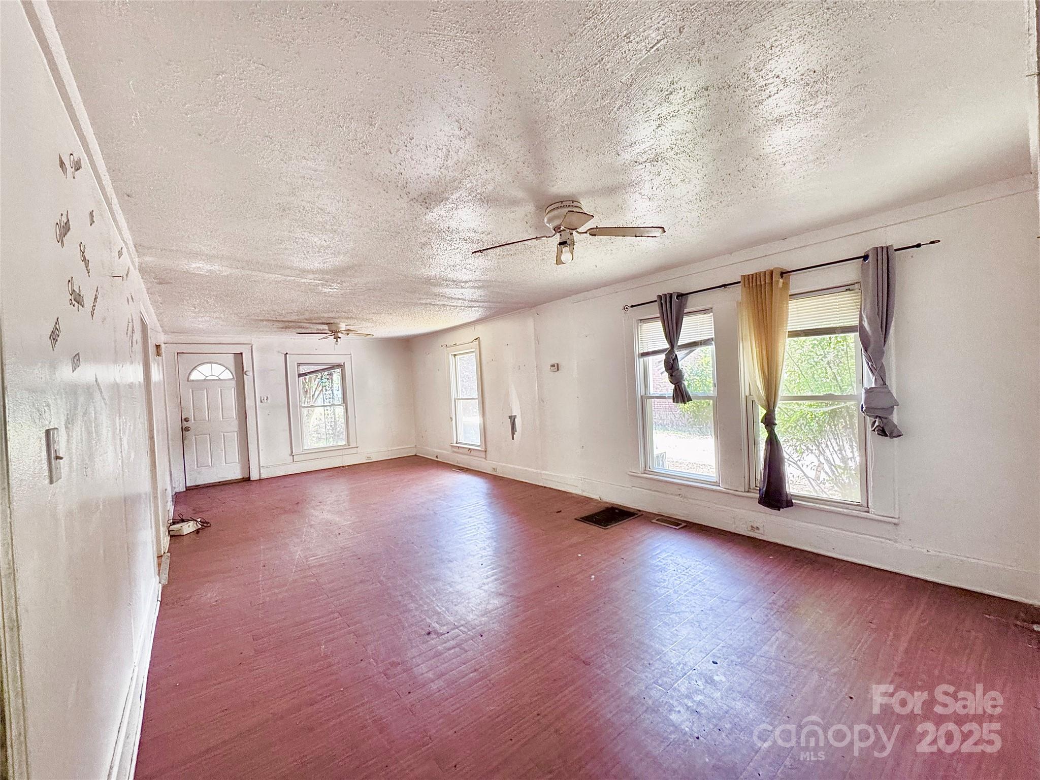 615 Fairview Street Kannapolis, NC 28083 - Photo 2 of 8 wooden floor in an empty room with a window