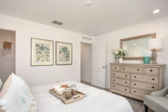 a bedroom with a bed and a dresser