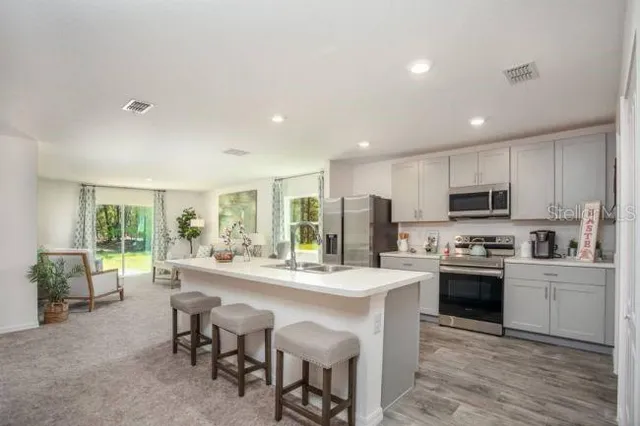 a kitchen with stainless steel appliances granite countertop a stove and a refrigerator
