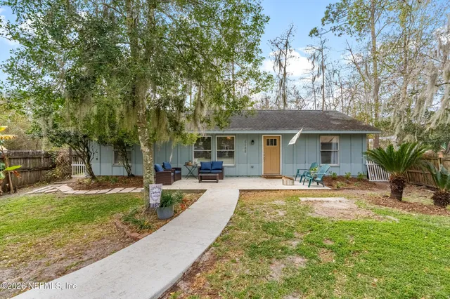a front view of a house with a yard and porch