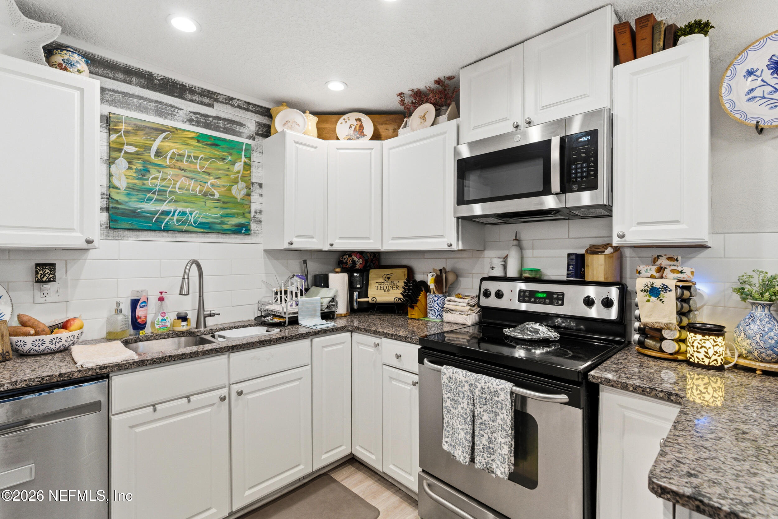 5188 Tan Street Jacksonville, FL 32258 - Photo 11 of 24 a kitchen with stainless steel appliances granite countertop a sink a stove and microwave