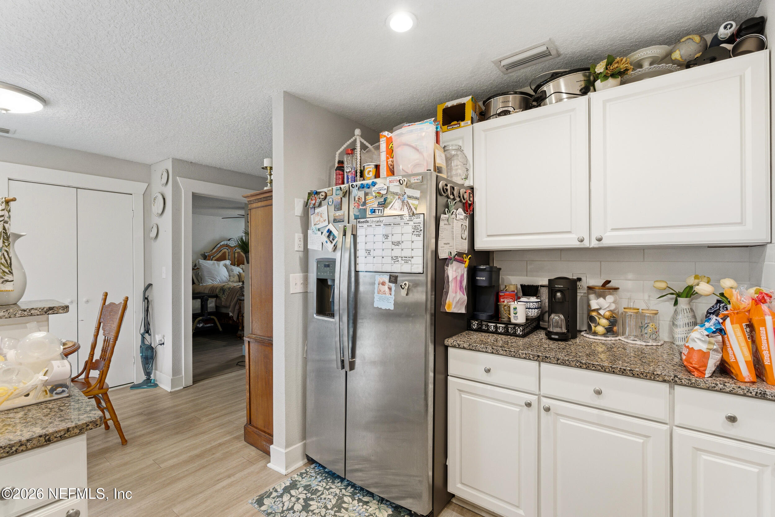 5188 Tan Street Jacksonville, FL 32258 - Photo 12 of 24 a kitchen with stainless steel appliances granite countertop a refrigerator and white cabinets