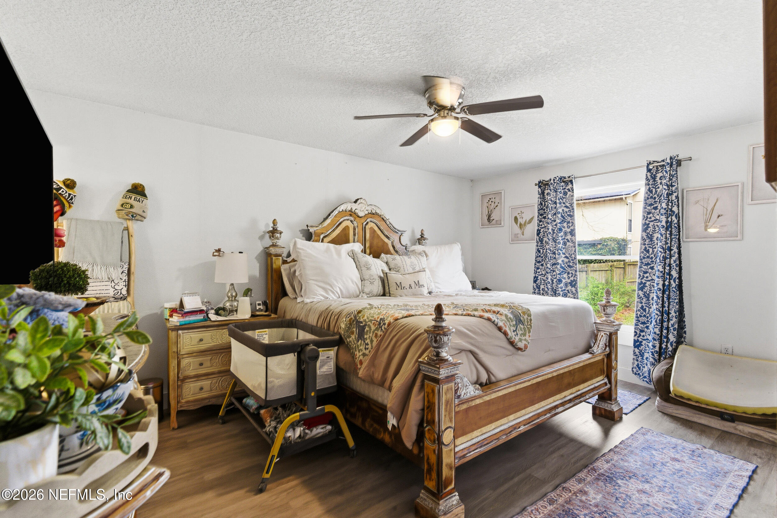 5188 Tan Street Jacksonville, FL 32258 - Photo 13 of 24 a bedroom with a bed and a chandelier