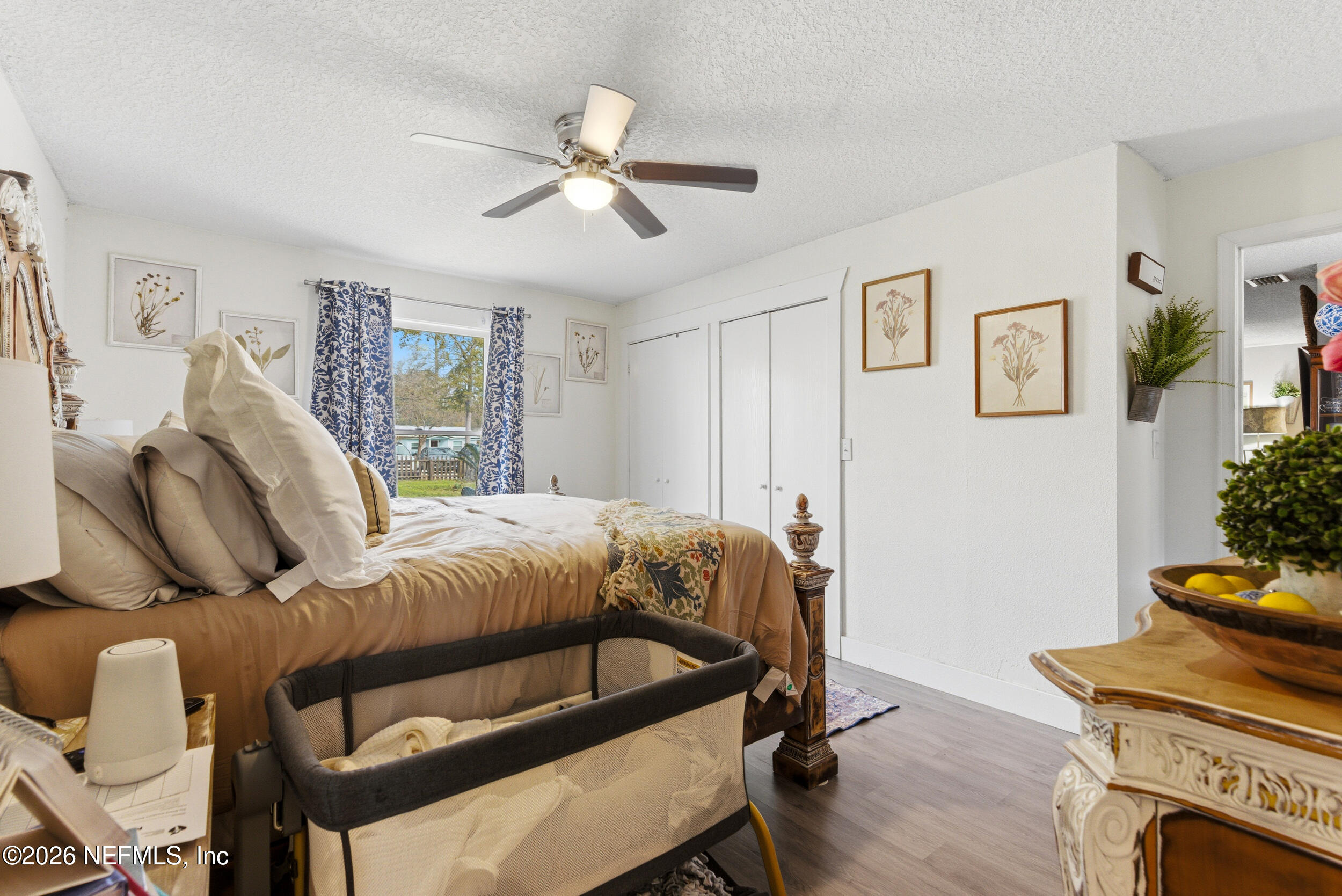 5188 Tan Street Jacksonville, FL 32258 - Photo 14 of 24 a bedroom with a bed and wooden floor