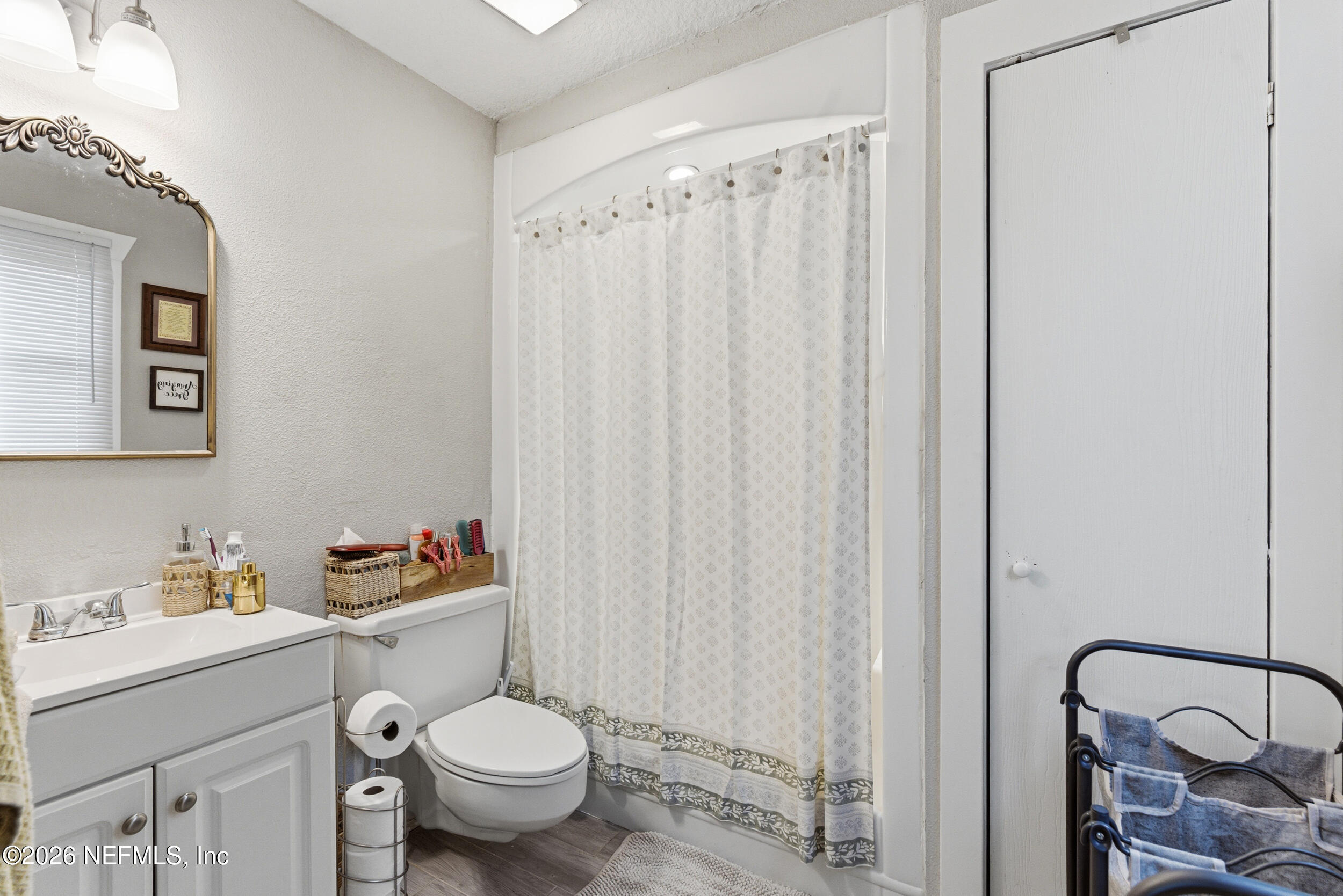 5188 Tan Street Jacksonville, FL 32258 - Photo 15 of 24 a white toilet sitting next to a bathroom sink