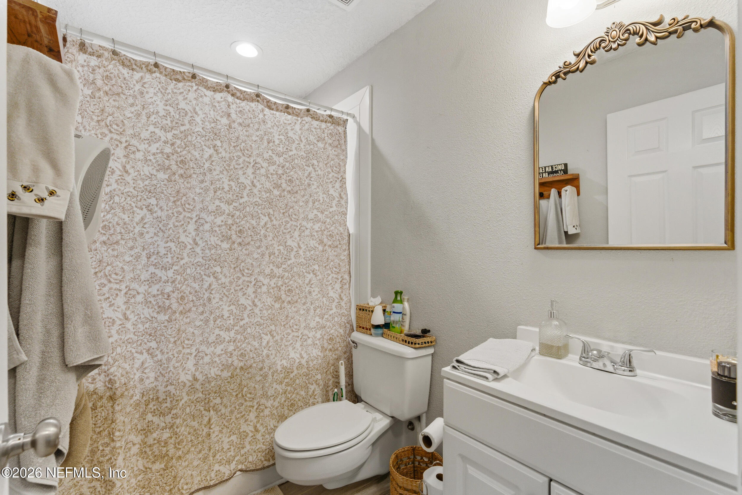 5188 Tan Street Jacksonville, FL 32258 - Photo 18 of 24 a white toilet sitting next to a bathroom sink