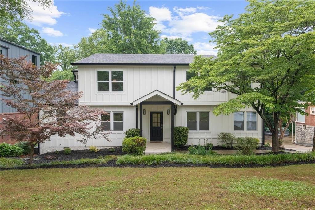 146 Mt Paran Road Northeast Atlanta, GA 30342 - Photo 1 of 1 a front view of a house with a garden