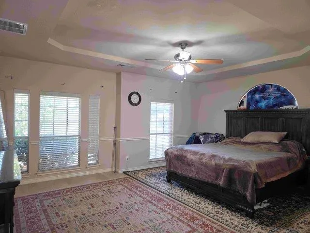 a bedroom with a bed dresser and a window