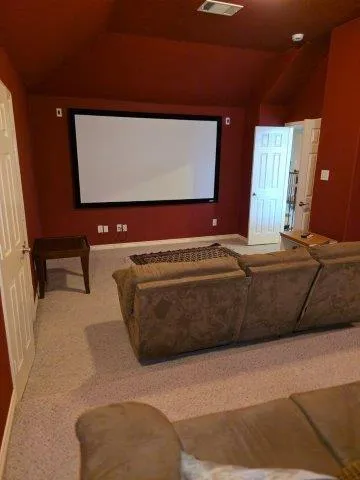 a living room with a couch and a bookshelf