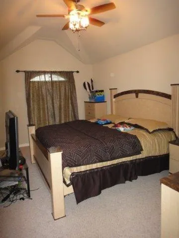 a bedroom with a bed and a chandelier