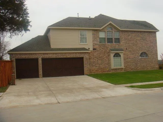 a front view of a house with garage and yard