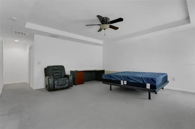 a living room with furniture and a air conditioner vent