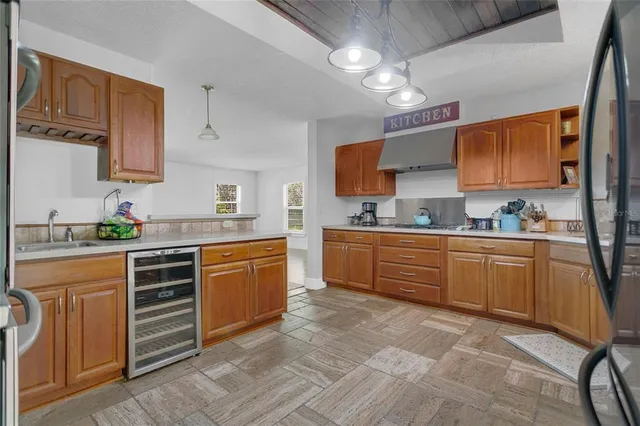 a kitchen with stainless steel appliances granite countertop a refrigerator sink stove microwave and cabinets
