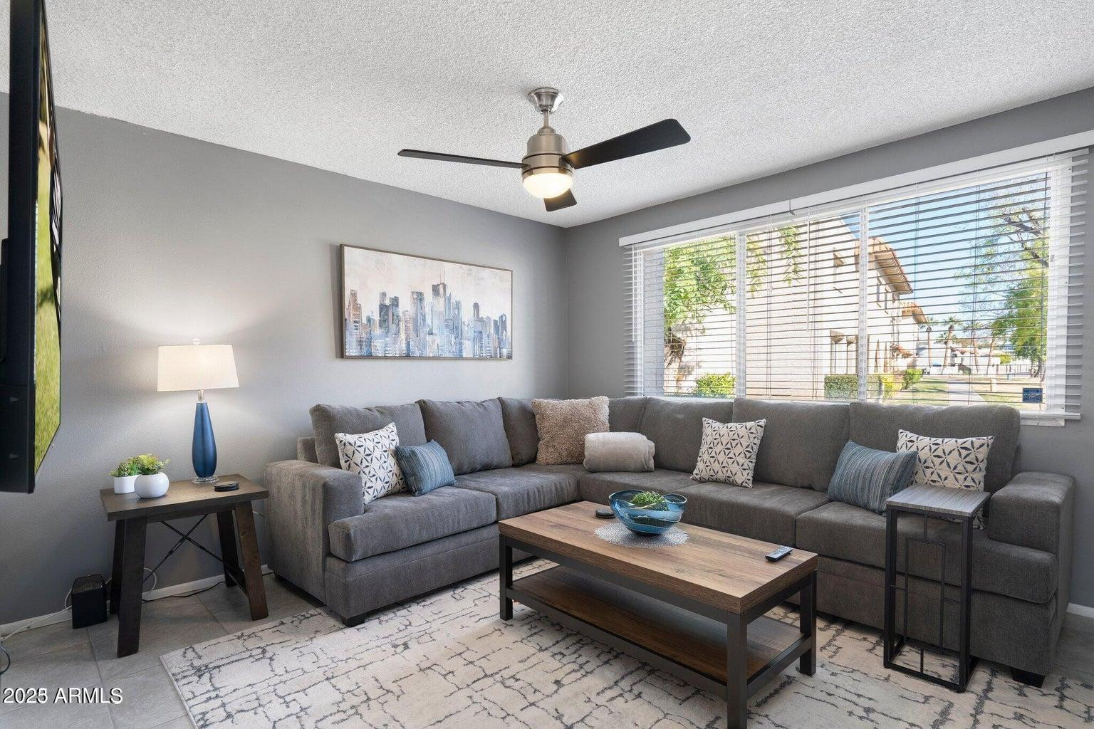 6921 East Osborn Road, Unit D Scottsdale, AZ 85251 - Photo 1 of 13 a living room with furniture and a large window