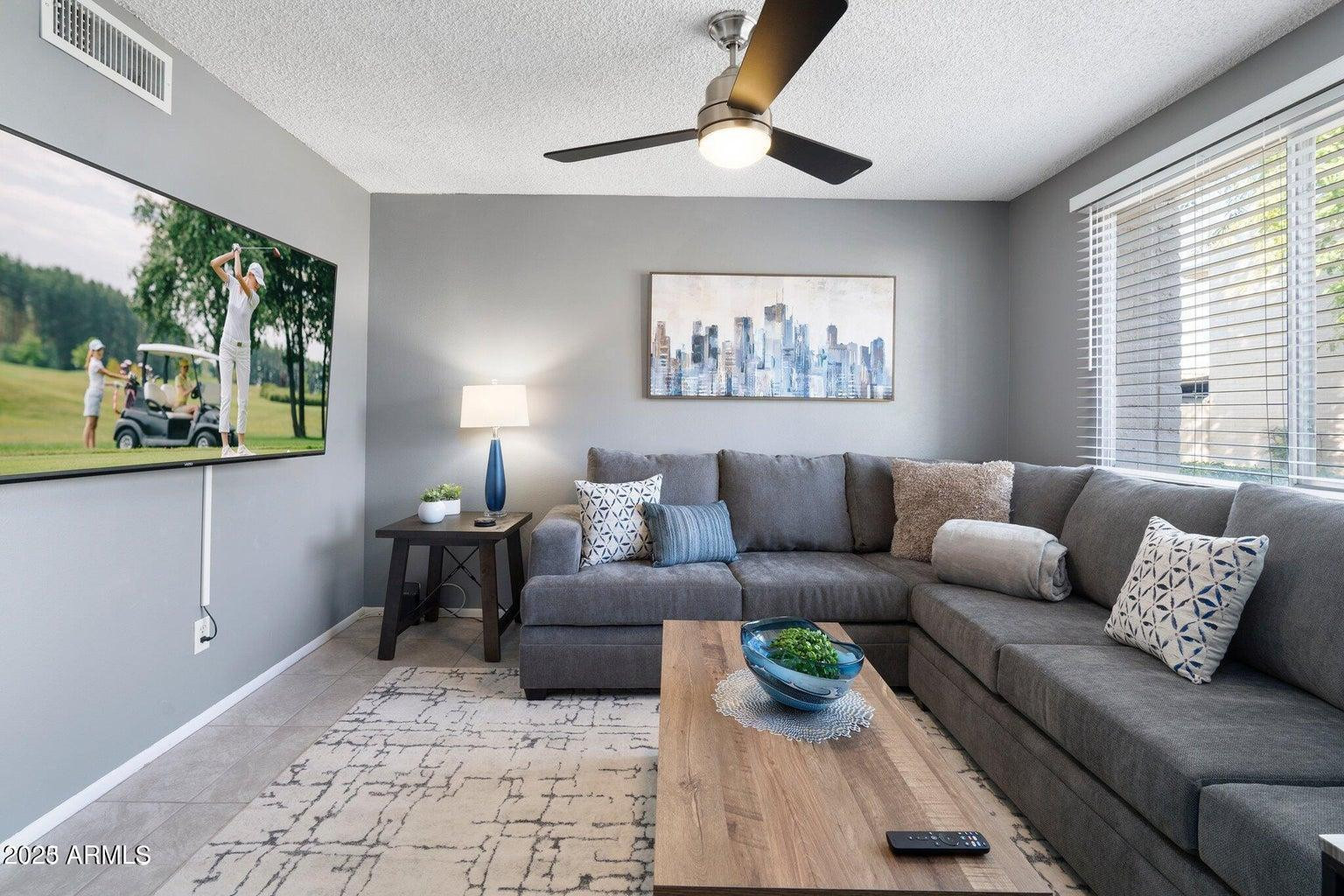 6921 East Osborn Road, Unit D Scottsdale, AZ 85251 - Photo 2 of 13 a living room with furniture and a large window