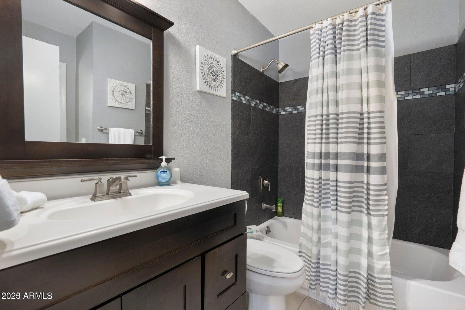 6921 East Osborn Road, Unit D Scottsdale, AZ 85251 - Photo 3 of 13 a bathroom with a sink a toilet and shower