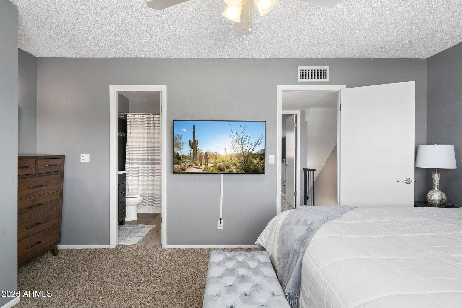 6921 East Osborn Road, Unit D Scottsdale, AZ 85251 - Photo 4 of 13 a bedroom with a bed and a mirror