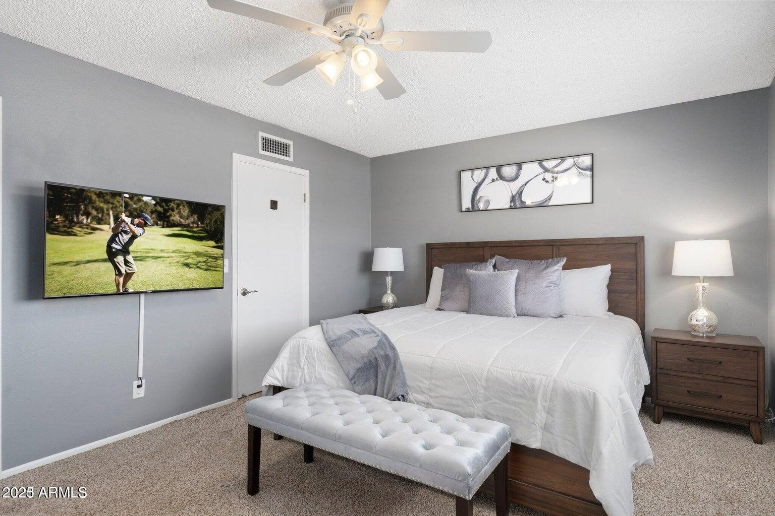 6921 East Osborn Road, Unit D Scottsdale, AZ 85251 - Photo 5 of 13 a bedroom with a bed and painting on the wall