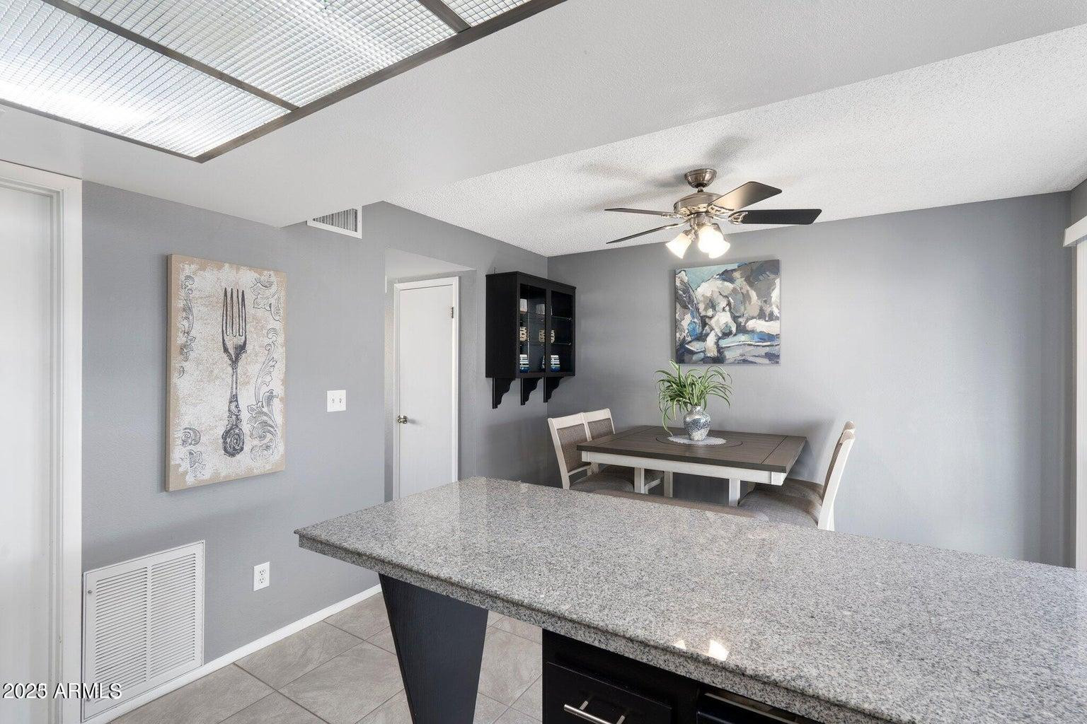 6921 East Osborn Road, Unit D Scottsdale, AZ 85251 - Photo 6 of 13 a view of a dining room with furniture and chandelier