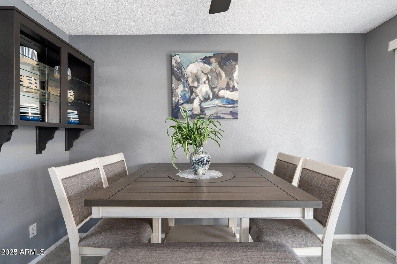 6921 East Osborn Road, Unit D Scottsdale, AZ 85251 - Photo 7 of 13 a dining room with furniture and wooden floor