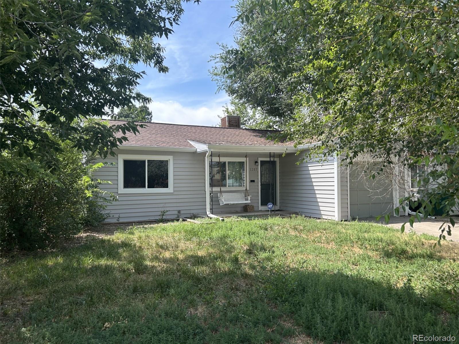 a backyard of a house with large trees