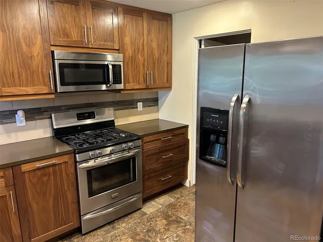 a kitchen with a stove and a microwave