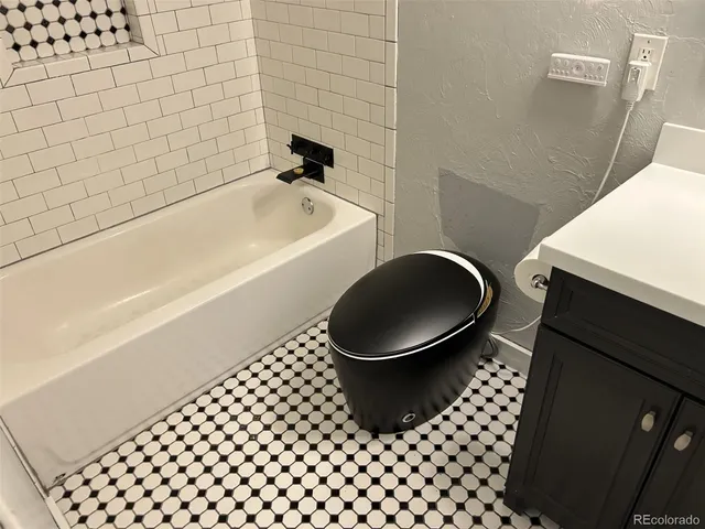 a bathroom with a bathtub and a shower