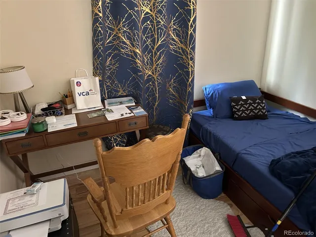 a bedroom with a bed and a desk