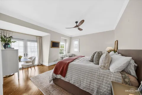 a bedroom with a large bed and a chandelier