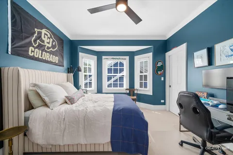 a bedroom with a bed and a desk