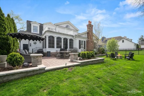 a view of a house with backyard sitting area and garden