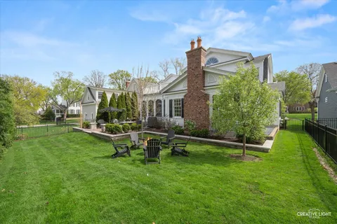 a view of a backyard with sitting area and garden
