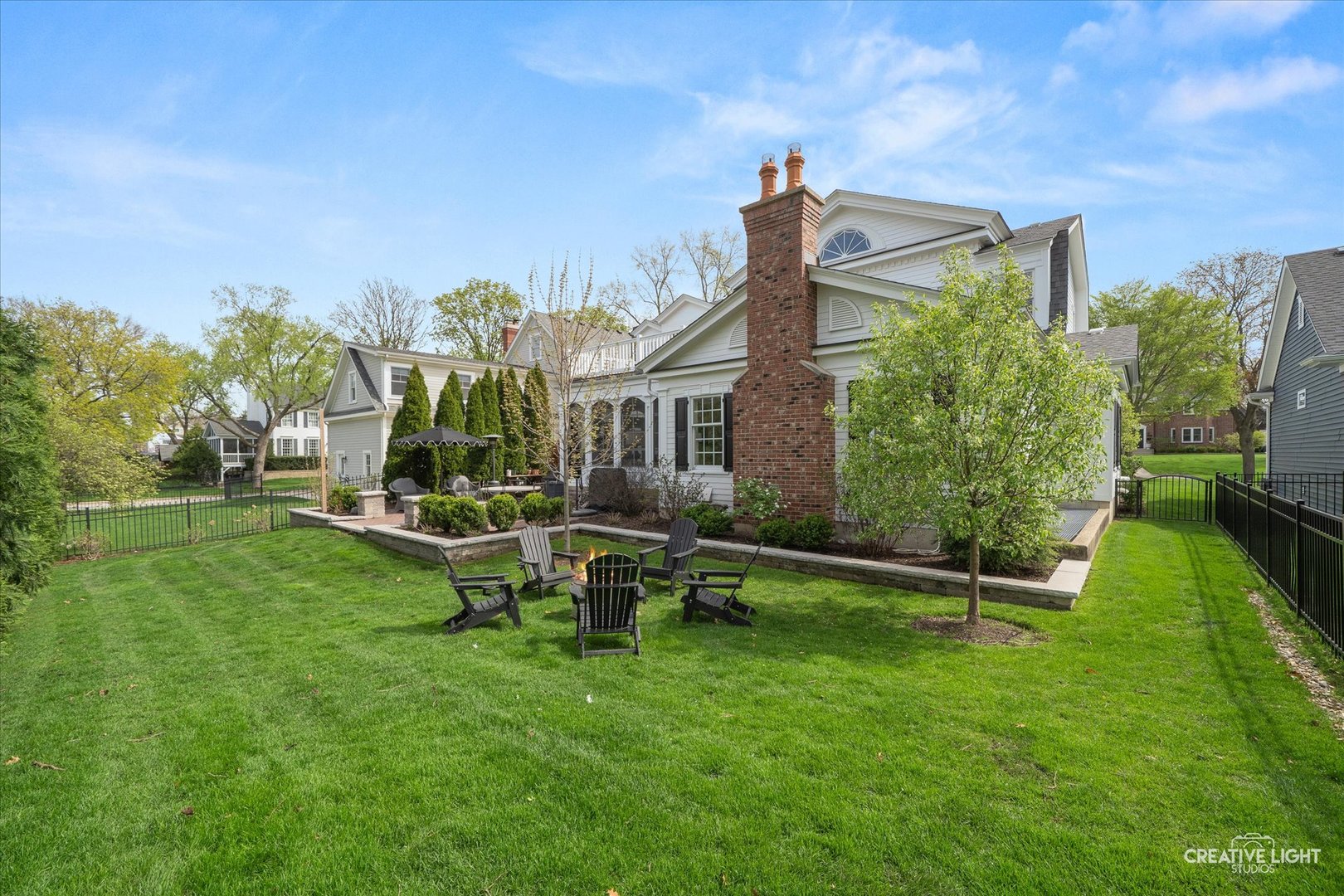920 North Washington Street Wheaton, IL 60187 - Photo 41 of 43 a view of a house with backyard sitting area and garden